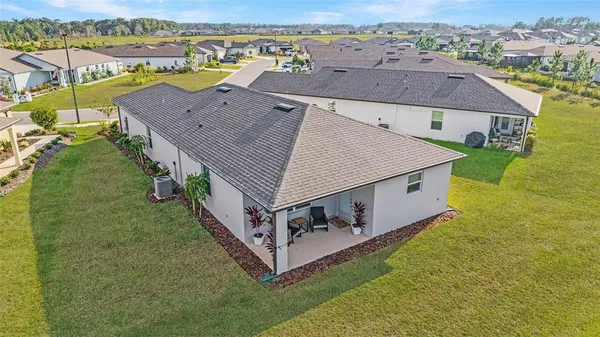 an aerial view of a house with a yard