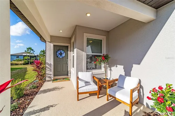 a view of a dining room with furniture and a potted plant