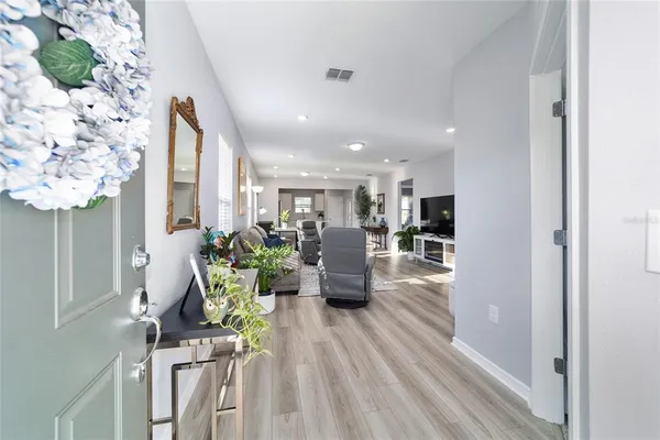 a living room with furniture dining table and a potted plant