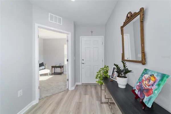 a hallway with a dining table and chairs