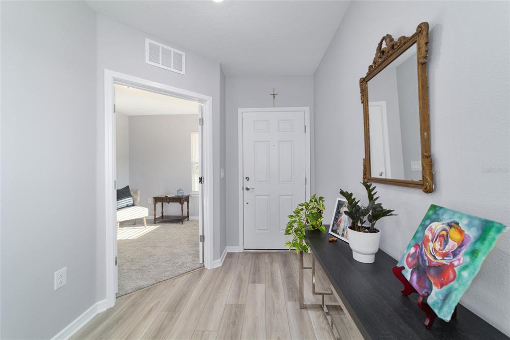 5472 Southwest 85th Ave Road Ocala, FL 34481 - Photo 5 of 44 a hallway with a dining table and chairs