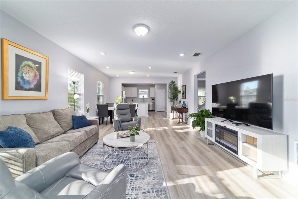 5472 Southwest 85th Ave Road Ocala, FL 34481 - Photo 9 of 44 a living room with furniture and a flat screen tv