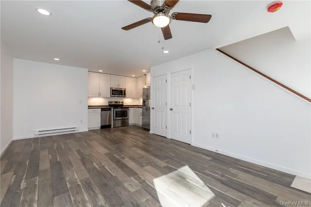 a view of kitchen with microwave and white cabinets