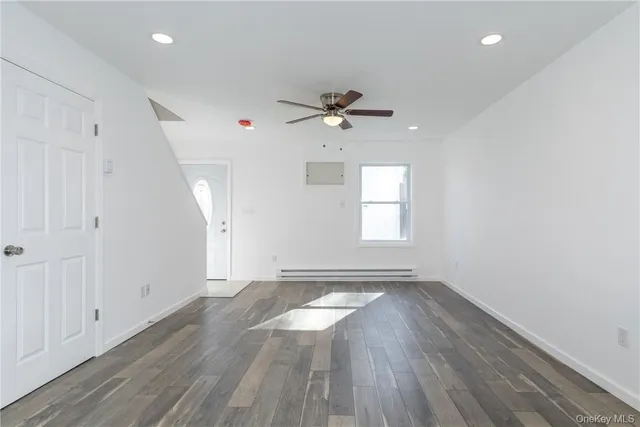 wooden floor in an empty room with a window