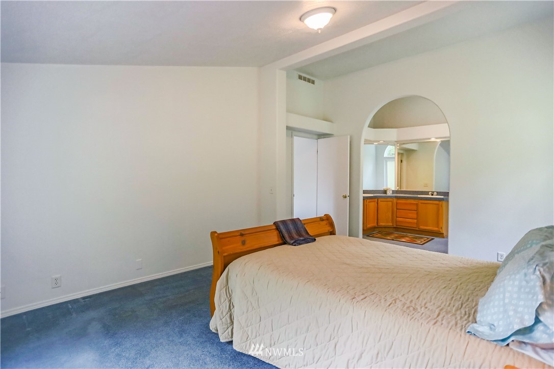 1763 Bunker Creek Road Chehalis, WA 98532 - Photo 24 of 40 a bedroom with a bed and a mirror