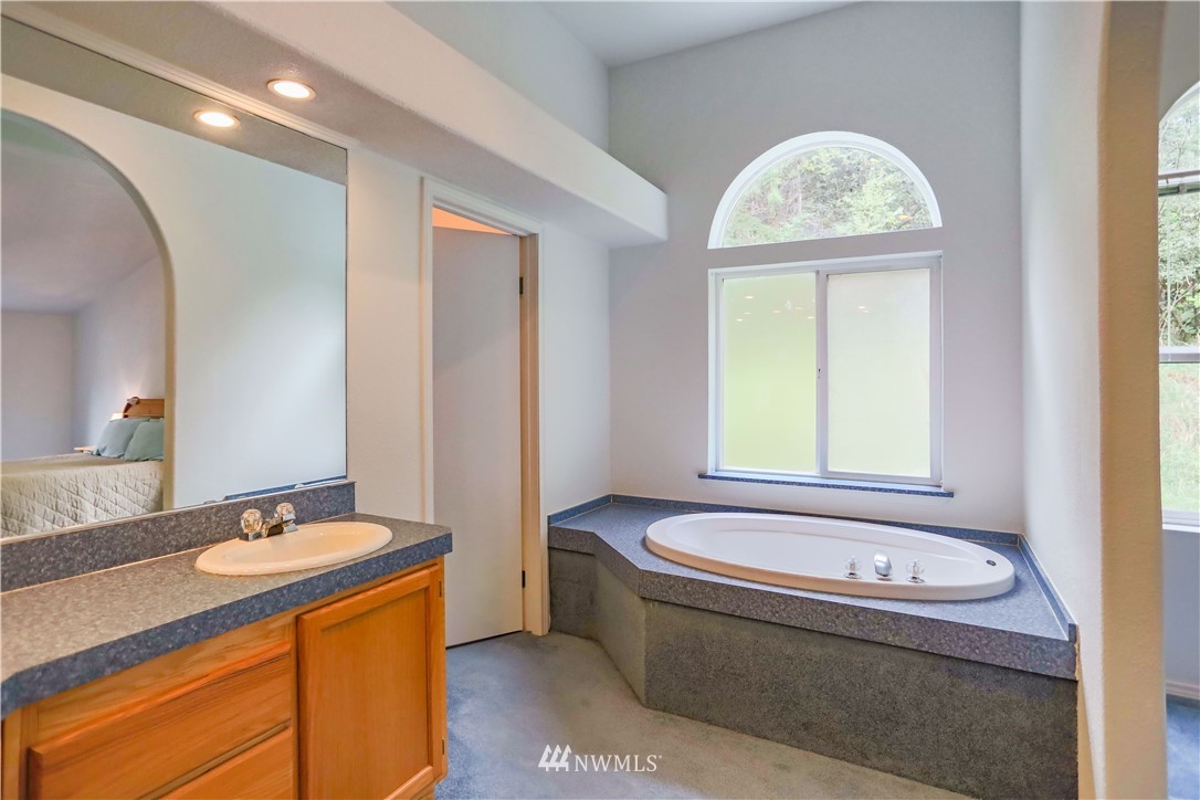 1763 Bunker Creek Road Chehalis, WA 98532 - Photo 27 of 40 a bathroom with a tub a sink and a window
