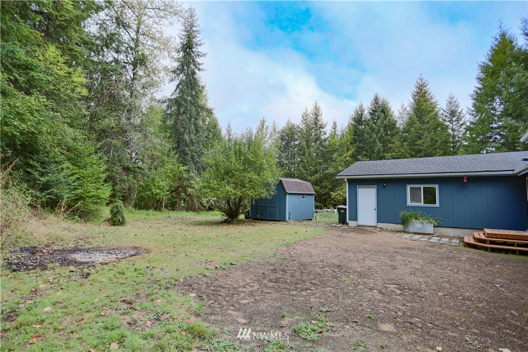 1763 Bunker Creek Road Chehalis, WA 98532 - Photo 4 of 40 a backyard of a house with oven and wooden fence