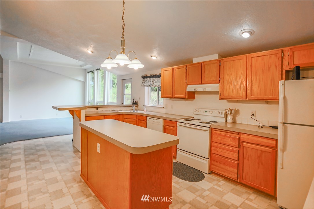 1763 Bunker Creek Road Chehalis, WA 98532 - Photo 7 of 40 a kitchen with stainless steel appliances granite countertop a sink a stove and a refrigerator