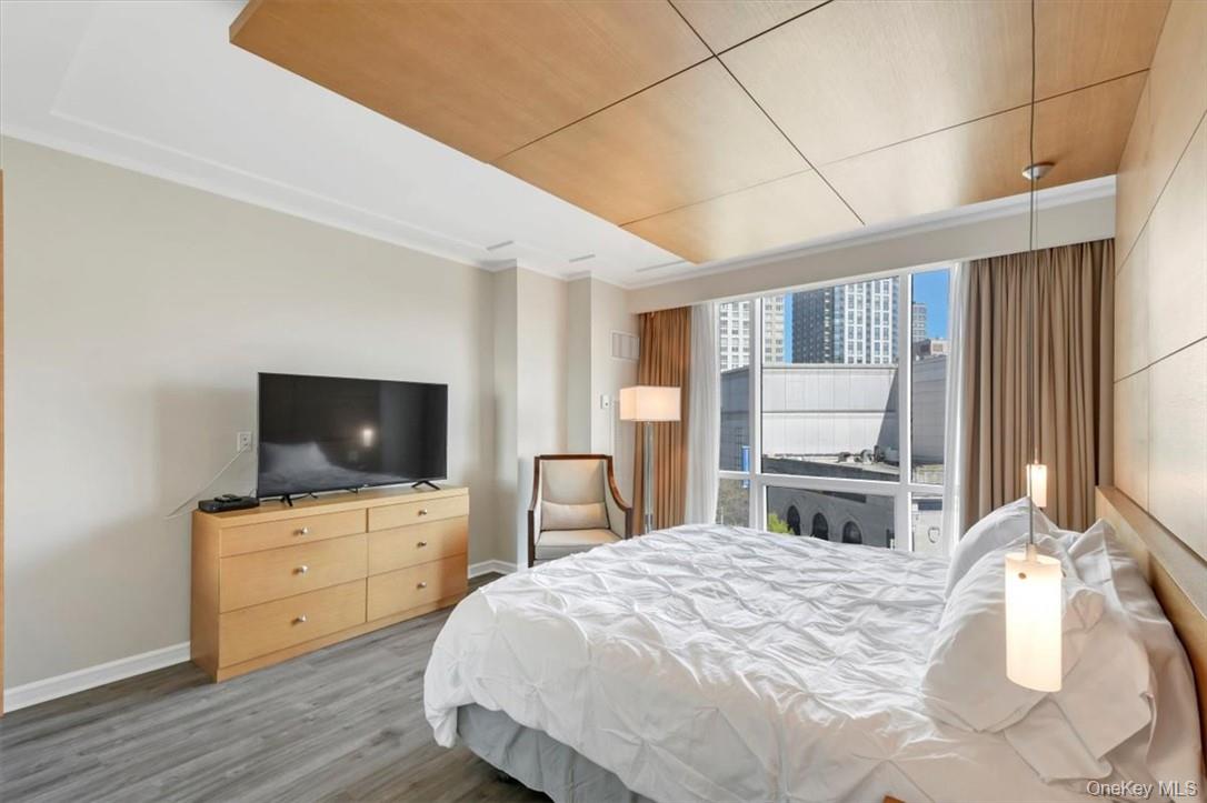 1 Renaissance Square, Unit 9D White Plains, NY 10601 - Photo 7 of 17 a bedroom with a bed and a flat screen tv