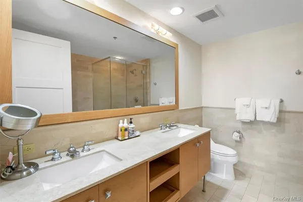 a bathroom with a sink double vanity and a mirror