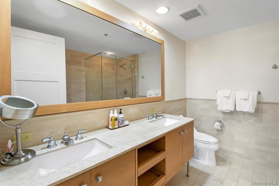1 Renaissance Square, Unit 9D White Plains, NY 10601 - Photo 8 of 17 a bathroom with a sink double vanity and a mirror