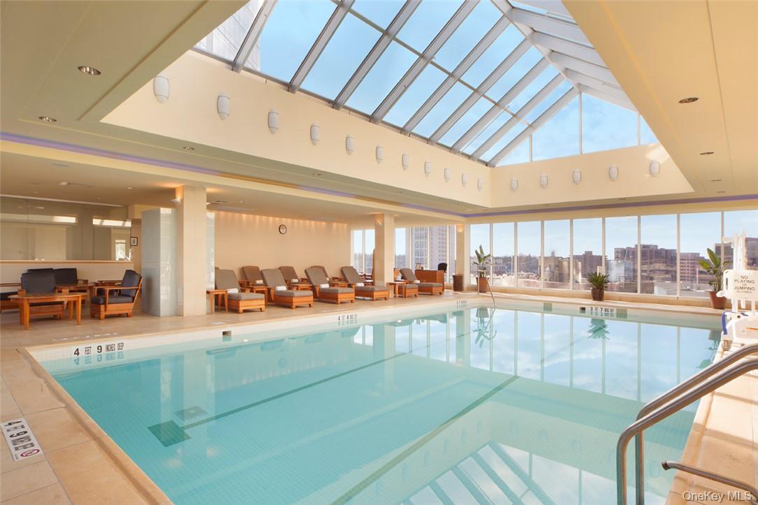 1 Renaissance Square, Unit 9D White Plains, NY 10601 - Photo 10 of 17 a room with lots of furniture and a large window