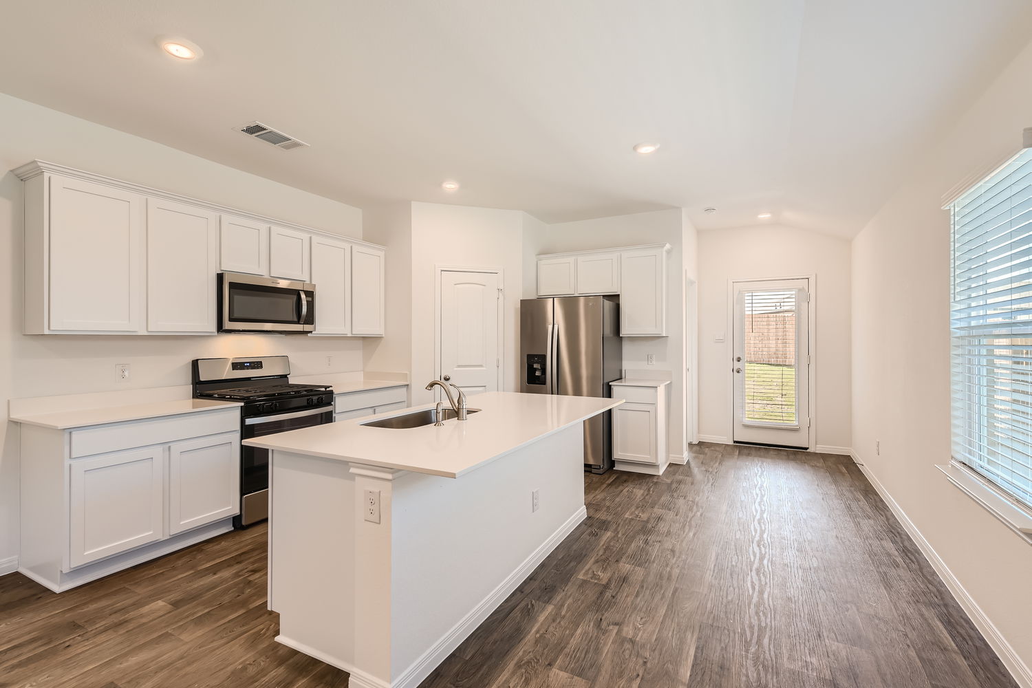 508 Gladiola Loop Kyle, TX 78640 - Photo 5 of 11 a kitchen with a sink a counter top space stainless steel appliances and a window