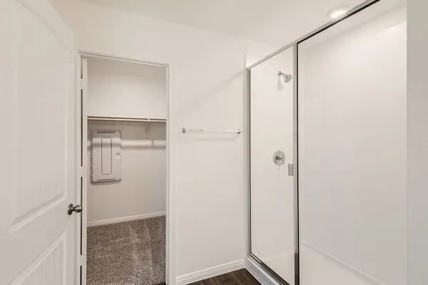 a bathroom with a glass shower door