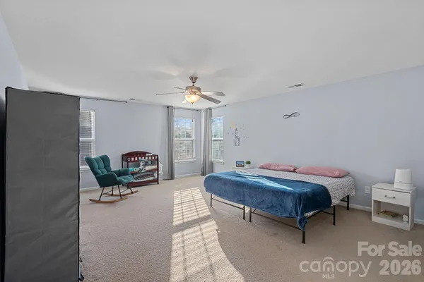 a bedroom with a bed and ceiling fan