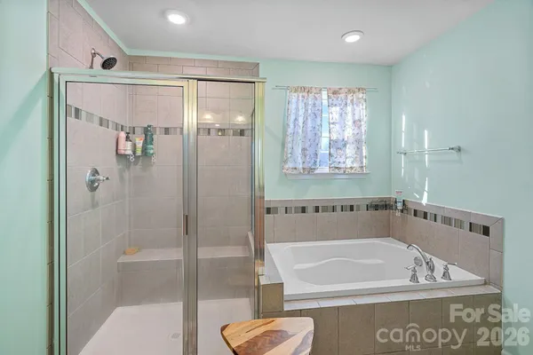 a bathroom with a tub and a shower