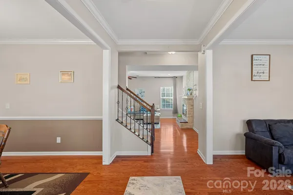 a living room with furniture and a table with wooden floor