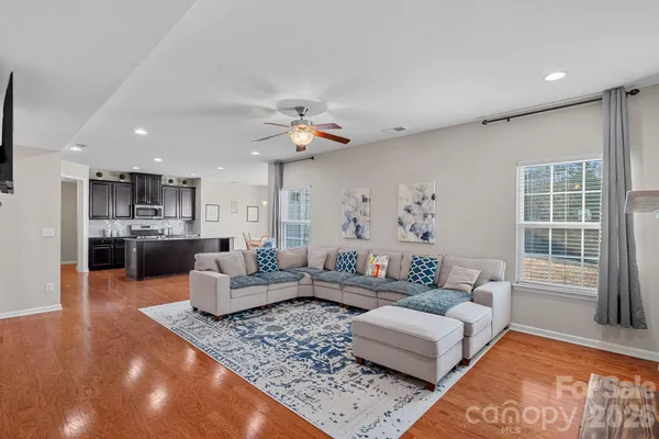 a living room with furniture and kitchen view