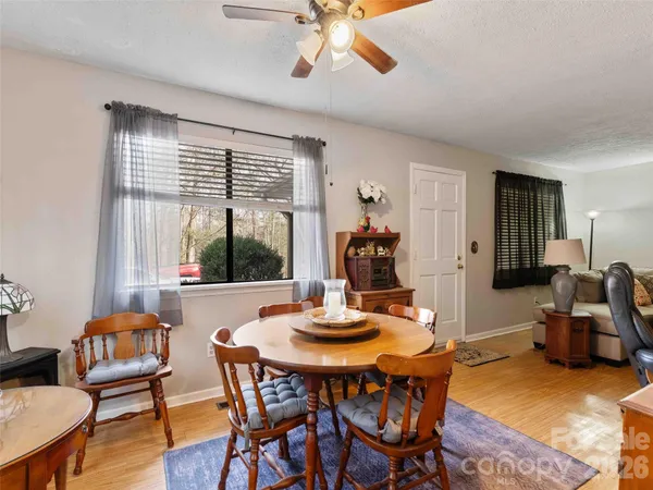 a dining room with furniture window and wooden floor