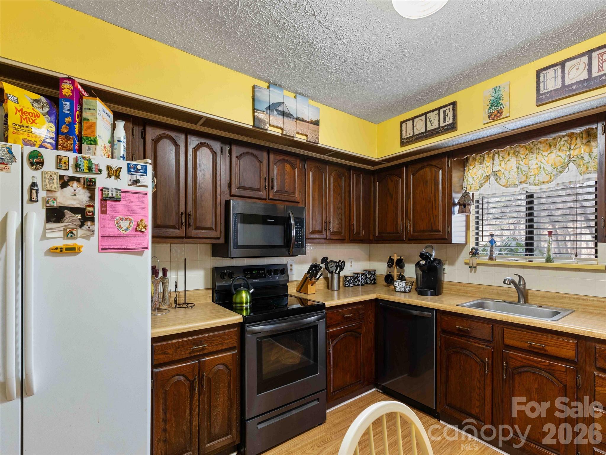 193 Freedom Road Hendersonville, NC 28792 - Photo 14 of 22 a kitchen with stainless steel appliances granite countertop a refrigerator and a sink