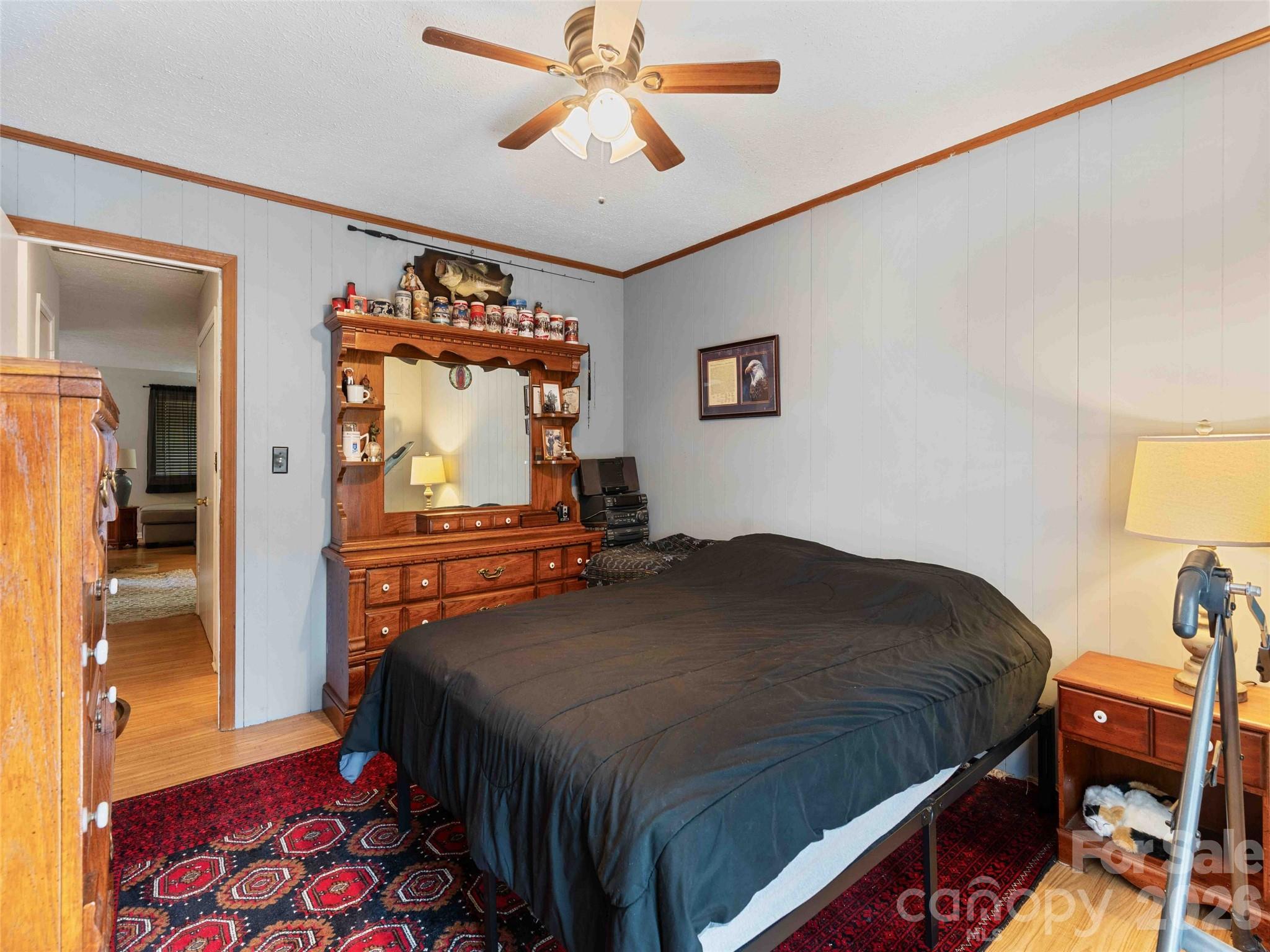 193 Freedom Road Hendersonville, NC 28792 - Photo 18 of 22 a bedroom with a bed and a chandelier