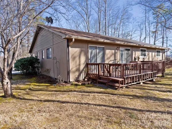 a view of a house with a yard next to a road