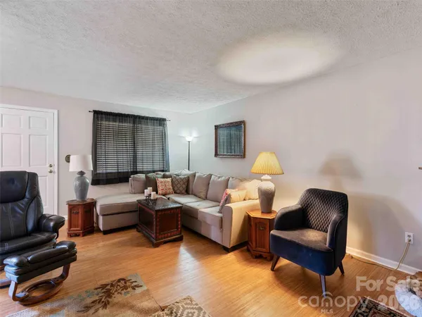 a living room with furniture and a lamp