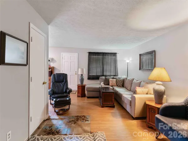 a living room with furniture and a lamp