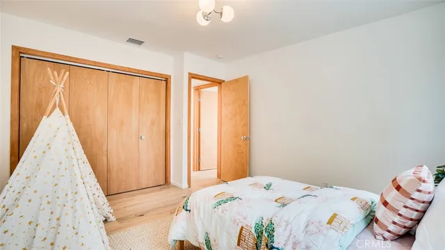 a view of a big yard with plants and large trees