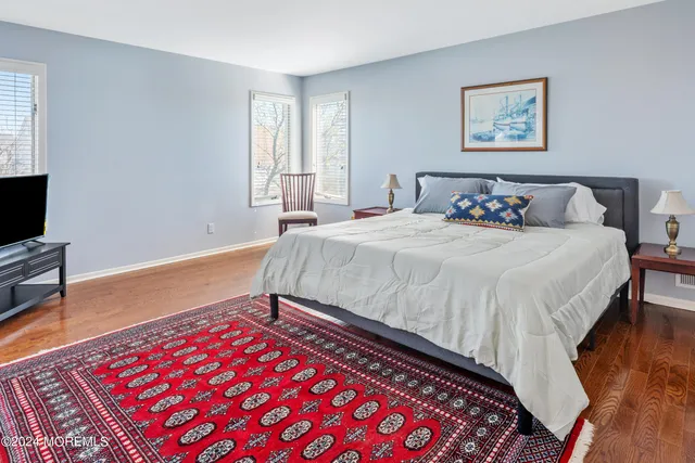 a bedroom with a bed and a tv on table