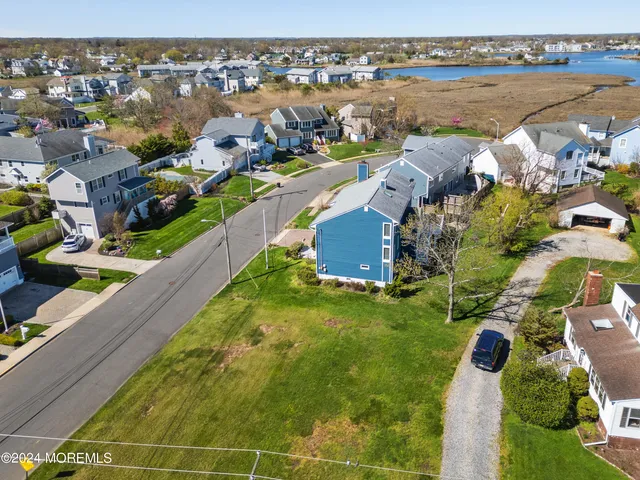 an aerial view of a house with a lake view