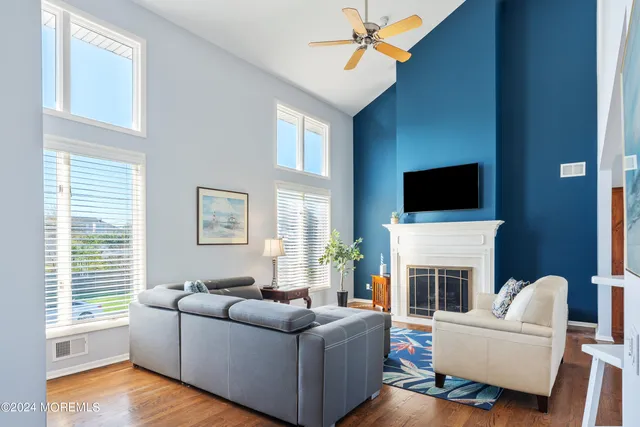a living room with furniture a fireplace and a flat screen tv