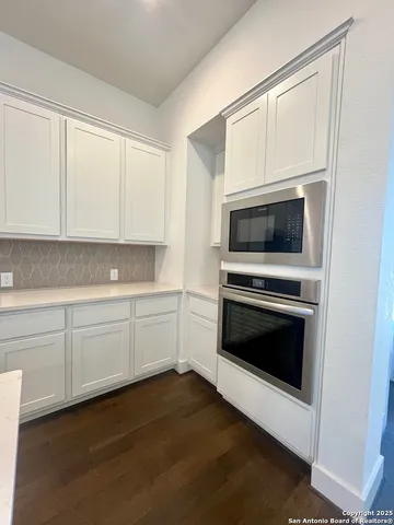 a close view of a stove a microwave and cabinets