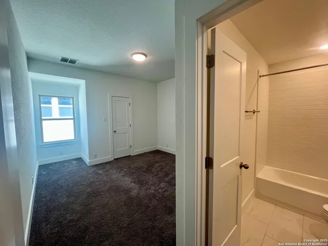 a bathroom with a double vanity sink toilet and shower