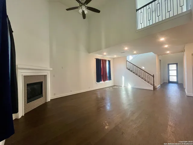 a view of a kitchen with kitchen island wooden floors appliances