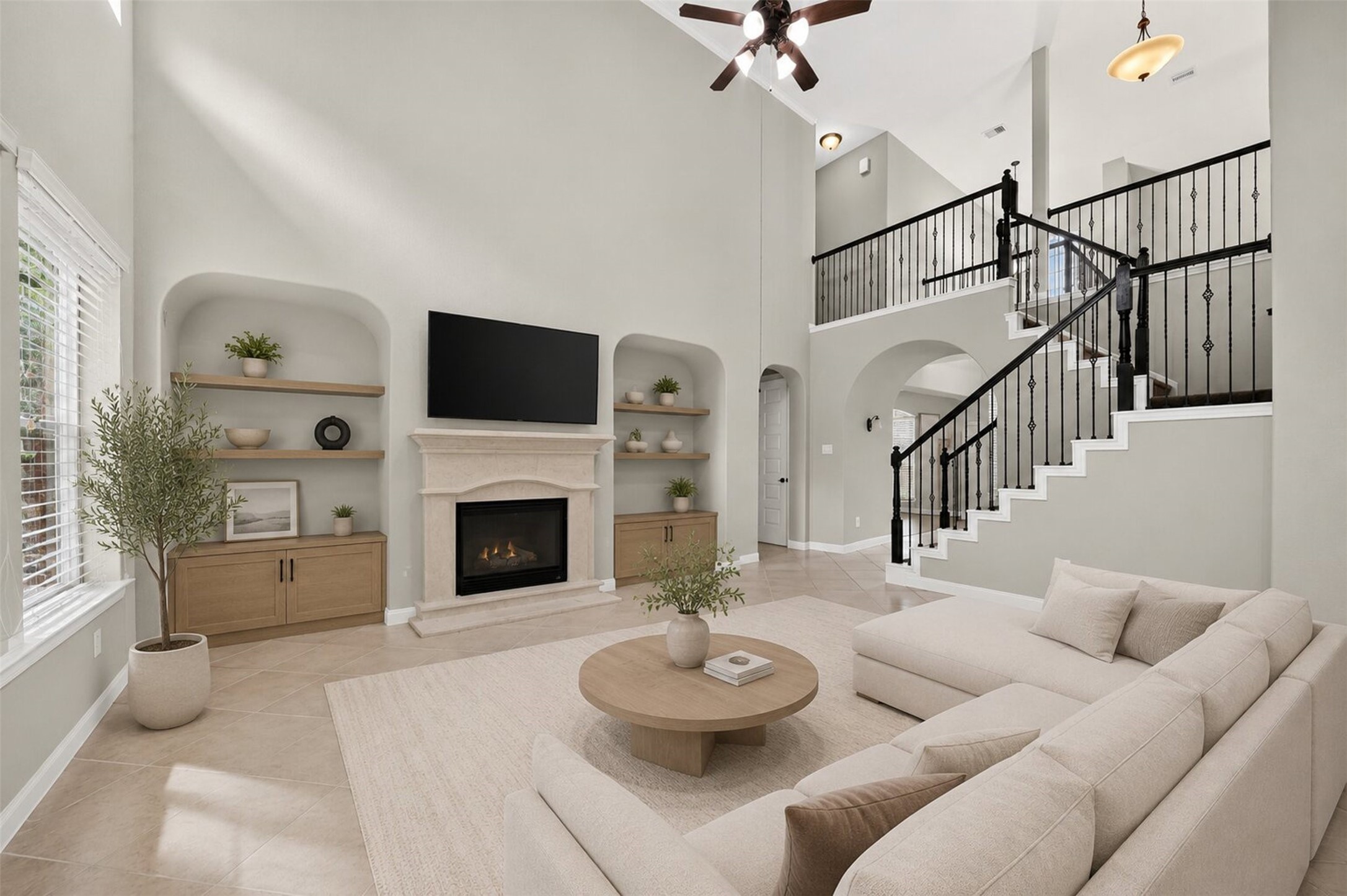 6234 Avon Landing Lane Spring, TX 77379 - Photo 13 of 49 The dramatic two-story ceiling height elevates the sense of space, while the second-floor catwalk with ornate wrought-iron railing creates a visual connection between the levels. This room has been virtually staged to show possibilities.