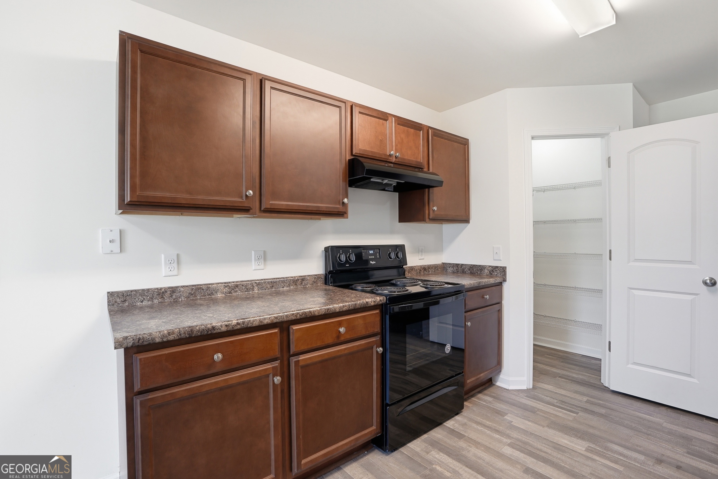 225 Rendell Lane Hinesville, GA 31313 - Photo 11 of 33 a kitchen with stainless steel appliances granite countertop a stove and a wooden cabinets