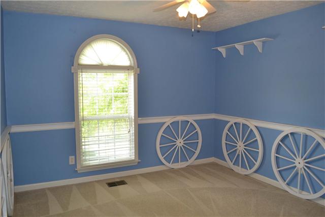 130 La View Road Hendersonville, TN 37075 - Photo 16 of 20 Third Bedroom....Features include a large, double door closet, custom chair rail with ledge, painted wagon wheel wainscotting, two mounted display shelves, lighted ceiling fan, and window with arched transom above & custom blind.