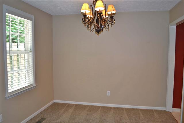 130 La View Road Hendersonville, TN 37075 - Photo 7 of 20 The Formal Dining Room enjoys a window that overlooks the backyard, contemporary iron chandelier, and a large cased opening to the Living Room.