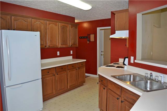 130 La View Road Hendersonville, TN 37075 - Photo 8 of 20 The Eat-In Kitchen has a full size pantry, pass thru window to Living Room, & all white appliances that include a stove, dishwasher, & refrigerator with freezer on the bottom.
