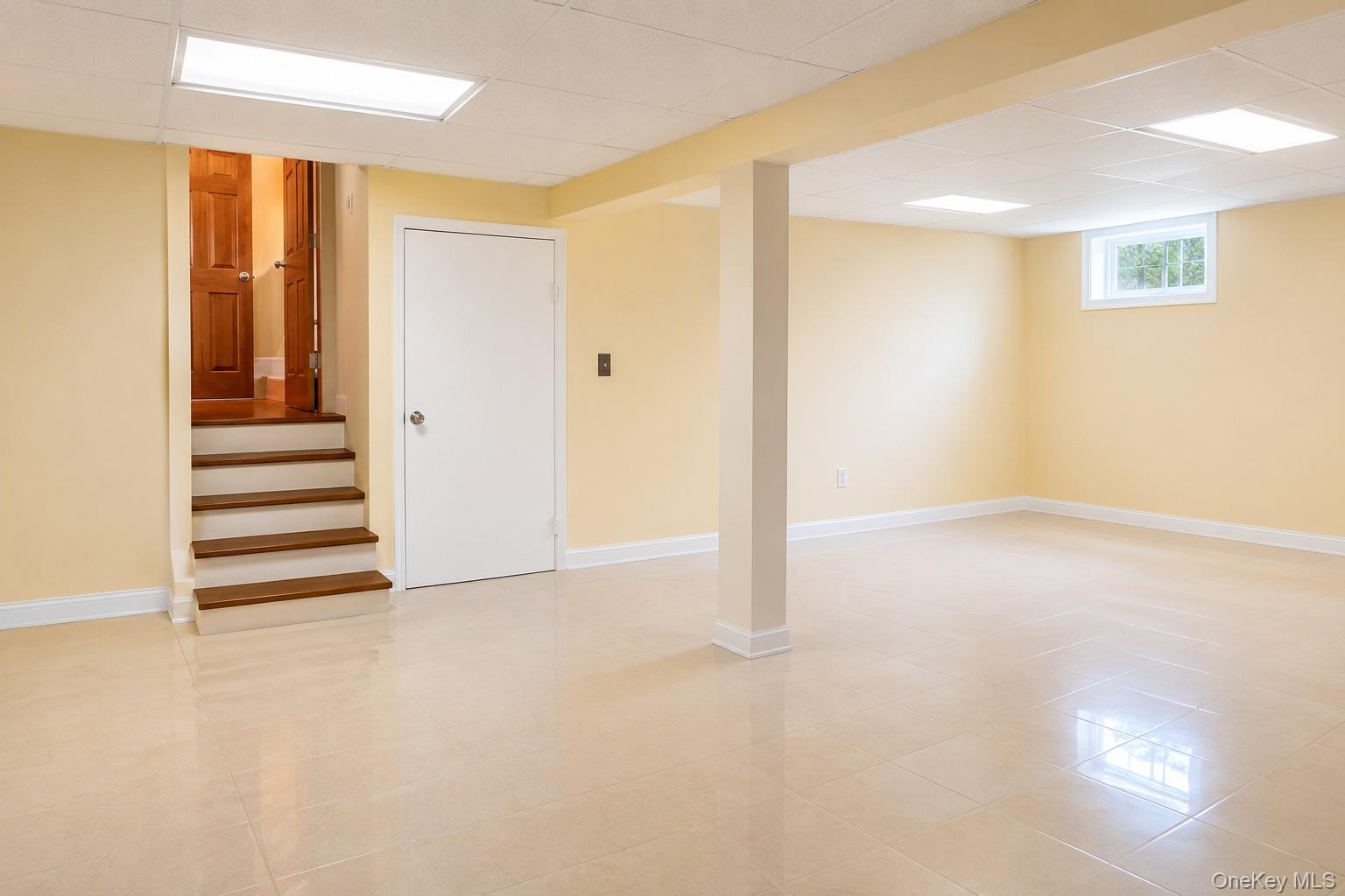 180 Sutton Manor Road New Rochelle, NY 10801 - Photo 6 of 9 a view of an empty room with wooden floor