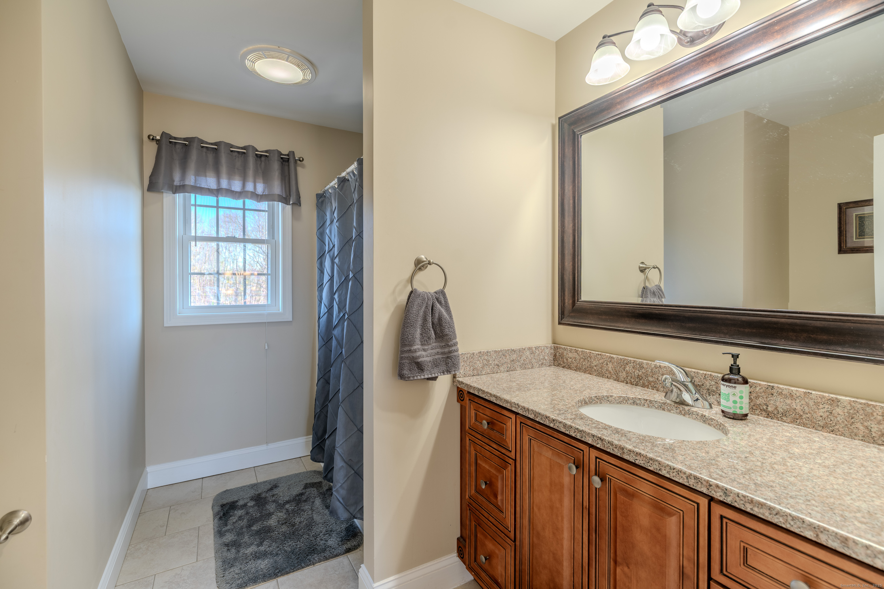 44 Trailside Crossing Middletown, CT 06457 - Photo 26 of 40 a bathroom with a granite countertop sink and a mirror