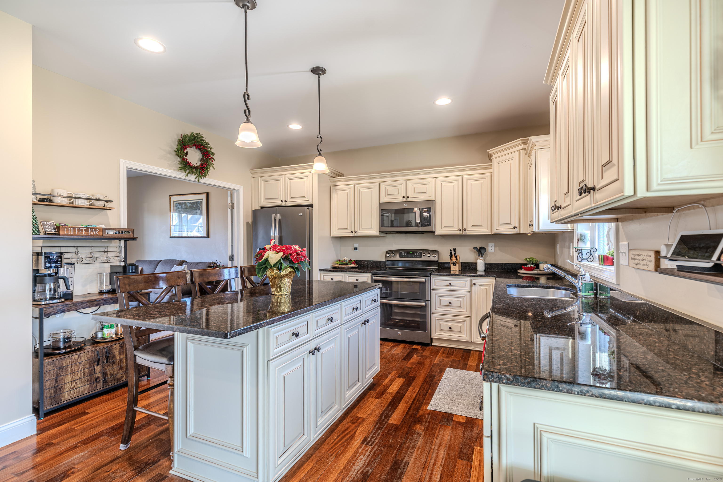 44 Trailside Crossing Middletown, CT 06457 - Photo 9 of 40 a kitchen with stainless steel appliances kitchen island granite countertop a stove top oven a sink dishwasher and white cabinets with wooden floor