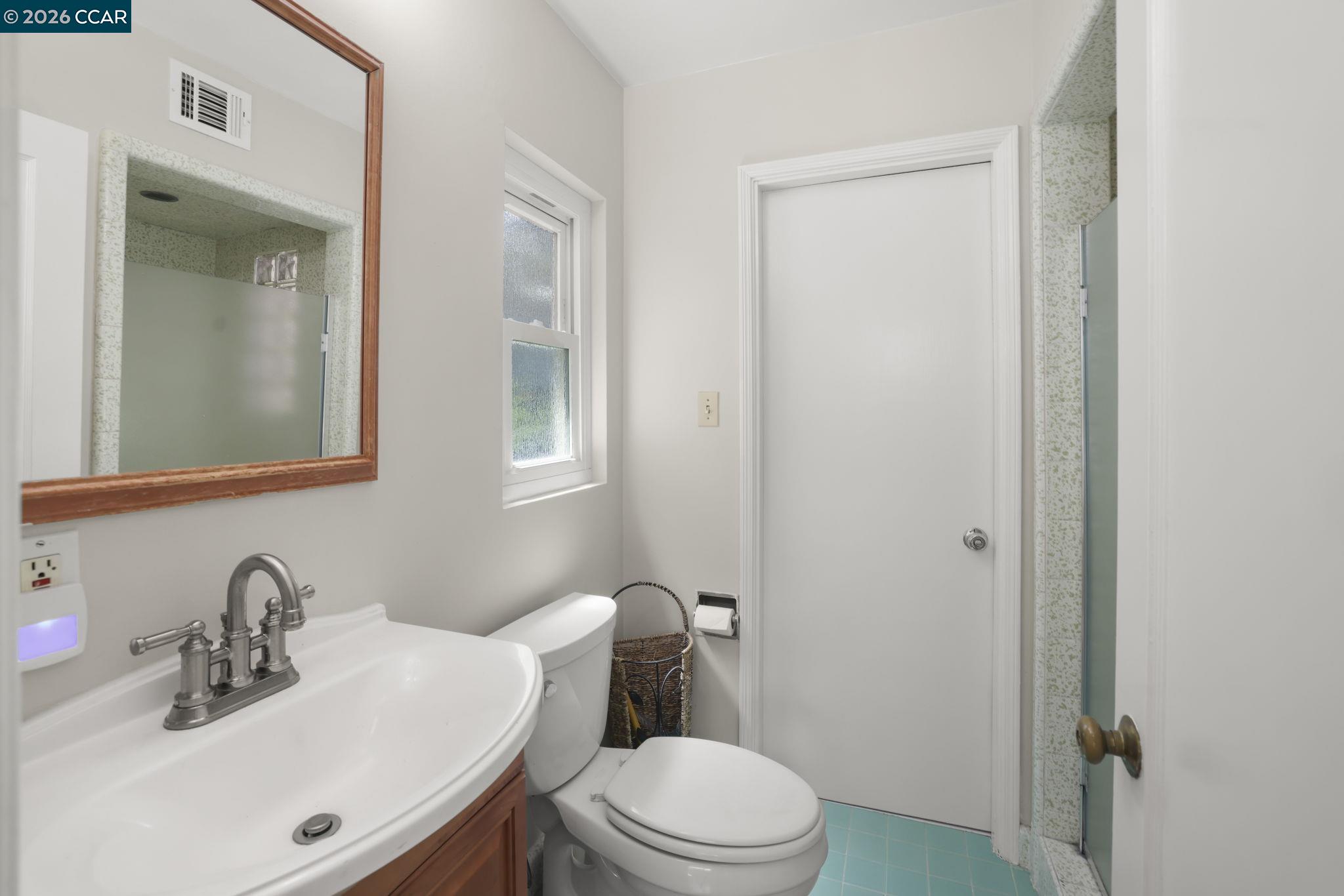 1051 San Rafael Street San Leandro, CA 94577 - Photo 20 of 26 a bathroom with a sink a toilet and shower