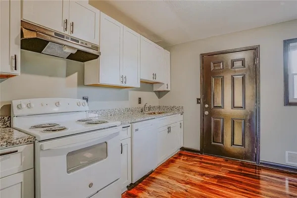 a kitchen with stainless steel appliances granite countertop a sink and cabinets