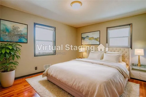 a bedroom with a bed and a painting on the wall