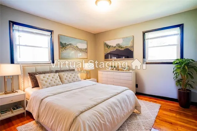 a bedroom with a bed and a potted plant