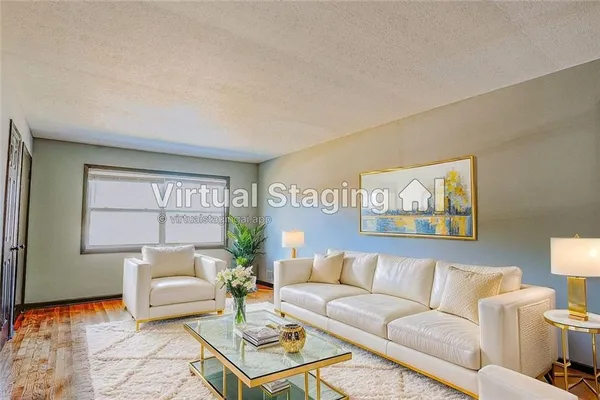 a living room with furniture and a potted plant