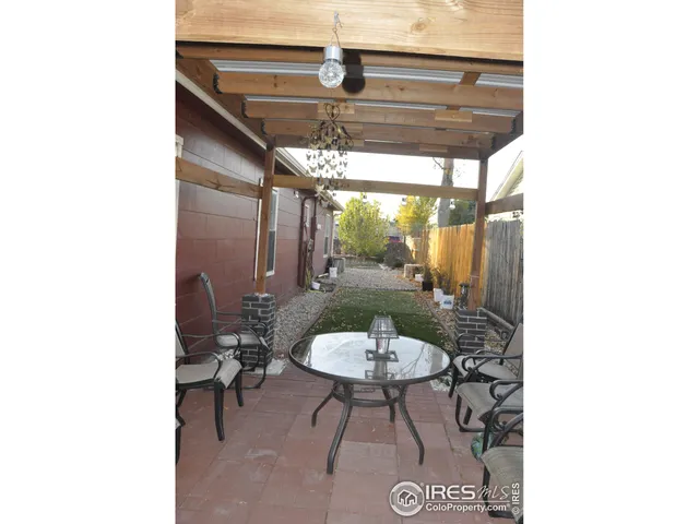 a outdoor space of a house with a sink and table