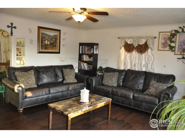 a living room with furniture and a painting